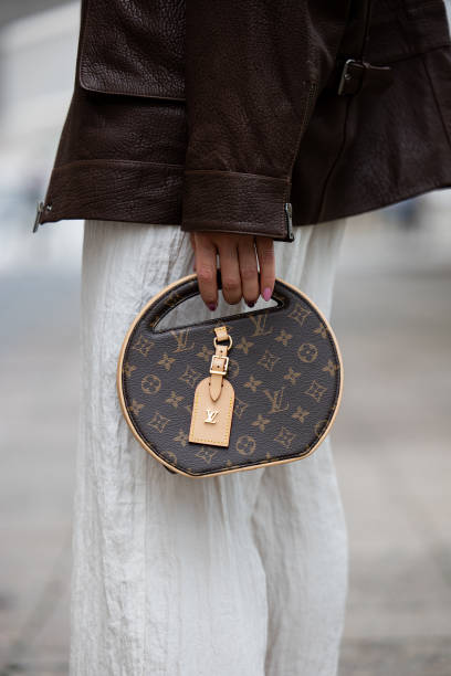 Sonia Lyson wears white pants Zara, brown leather jacket Ducie London, Louis Vuitton round bag on the way to Lueder during the Berlin Fashion Week...