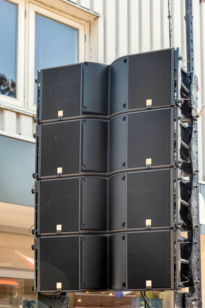sound system speakers hang outside from a suspension construction - concert photos et images de collection