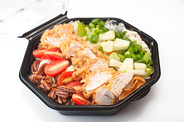 southern cobb salad in black plastic bowl - junk food stock pictures, royalty-free photos & images