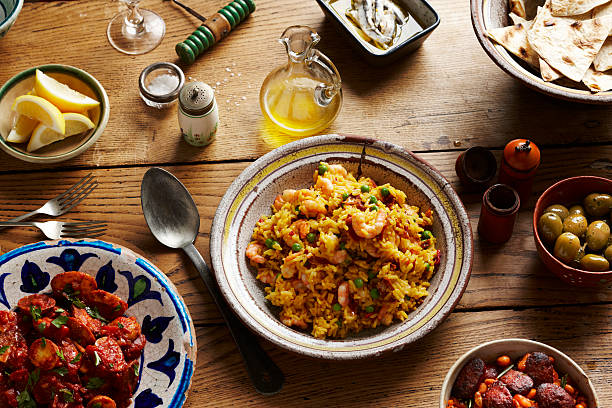 spanish tapas and paella on table - food stock pictures, royalty-free photos & images
