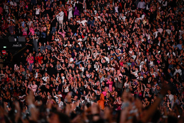 Spectators cheers as US singer and songwriter Taylor Alison Swift, also known as Taylor Swift performs on stage at the Paris La Defense Arena as part...