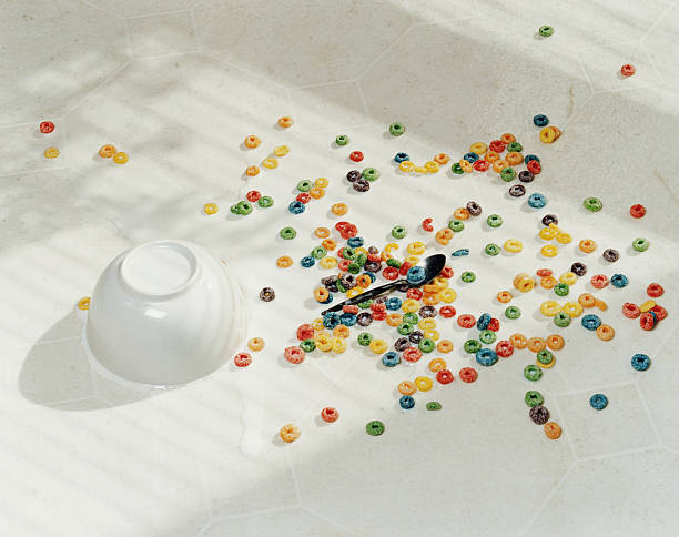spilt bowl of cereal on white floor - food stock pictures, royalty-free photos & images