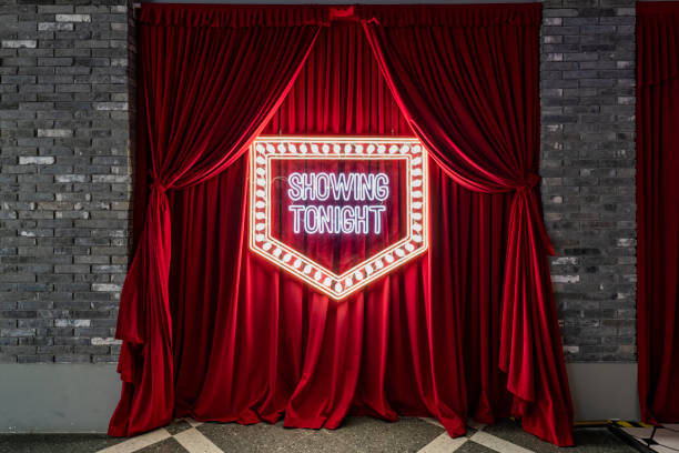 spotlight on opening red stage curtain - concert stock pictures, royalty-free photos & images
