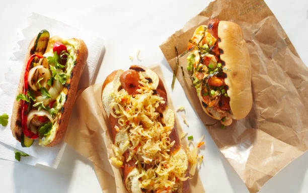 spread of three types of hot dogs - junk food stock pictures, royalty-free photos & images