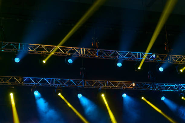 stage spotlights during music performance. - concert stock pictures, royalty-free photos & images