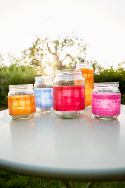 still life of handmade lanterns on table in garden at sunset - garden decoration stockfoto's en -beelden