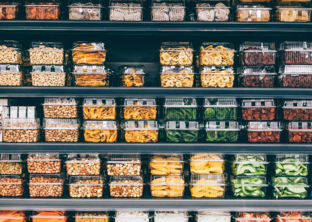 store shelves with dried fruit, veggies, and nuts in a non-ecological packaging - food stock pictures, royalty-free photos & images