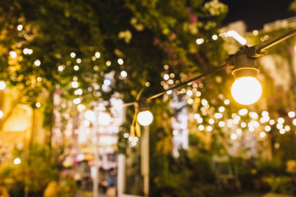 string light illuminated at night in the garden - garden decoration stock pictures, royalty-free photos & images