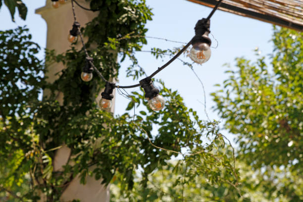 string of light bulbs at terrace - garden decoration stock pictures, royalty-free photos & images
