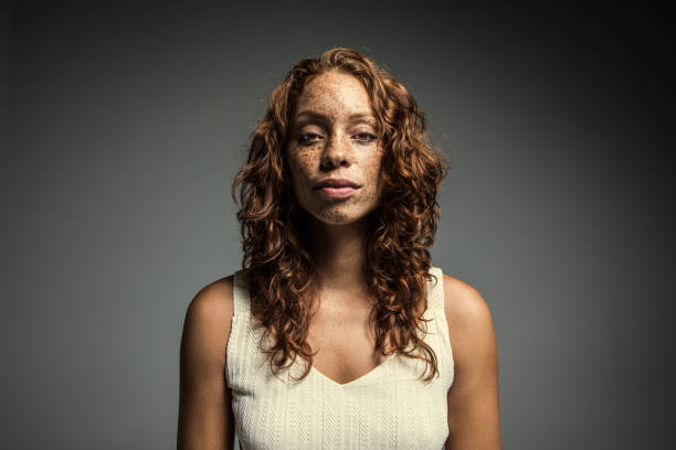 studio portrait of woman with freckles - fashion stock-fotos und bilder