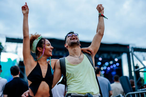 stylish couple enjoying music at concert - concert stock pictures, royalty-free photos & images