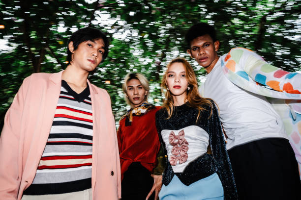 stylish group portrait featuring bold colors and creative fashion statements, capturing individuality and group synergy in a vibrant outdoor environment. - fashion stock pictures, royalty-free photos & images