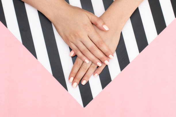 stylish trendy female white, black and blue manicure. beautiful young woman's hands on pink and white background. - nails art stock pictures, royalty-free photos & images