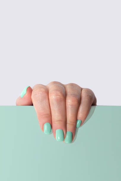 stylish trendy mint green color manicure on gray and mint background. - nails art stock pictures, royalty-free photos & images