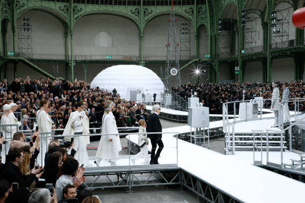 Stylist Karl Lagerfeld and his Godson Hudson Kroenig acknowledge the applause of the audience at the end of the Chanel show as part of the Paris...