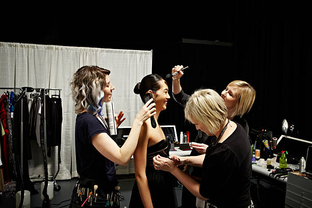 stylists and model backstage at fashion show - fashion week stock pictures, royalty-free photos & images