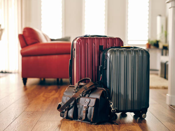 suitcases in a home ready for travel - travel stock pictures, royalty-free photos & images