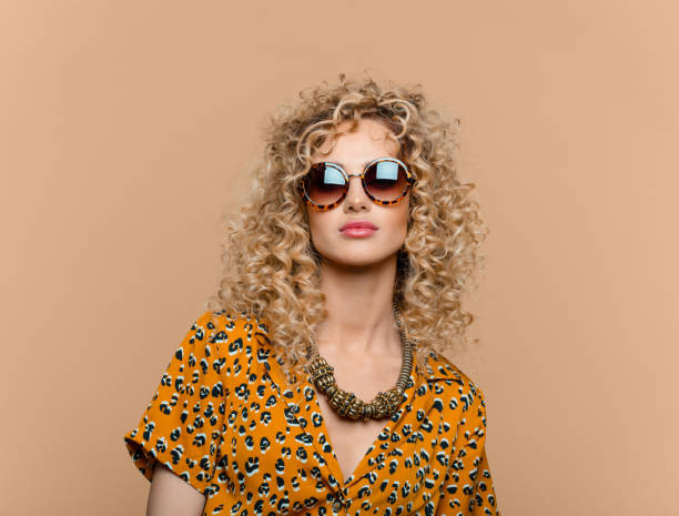 summer portrait of curly hair woman in leopard print dress - fashion stock pictures, royalty-free photos & images