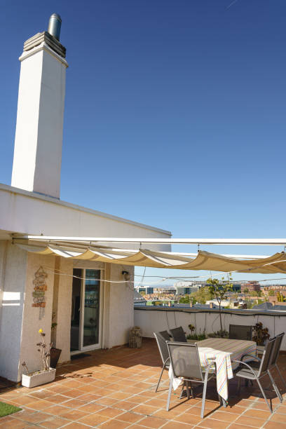 sunny terrace with vintage decoration and white awning over blue sky - garden decoration stock pictures, royalty-free photos & images