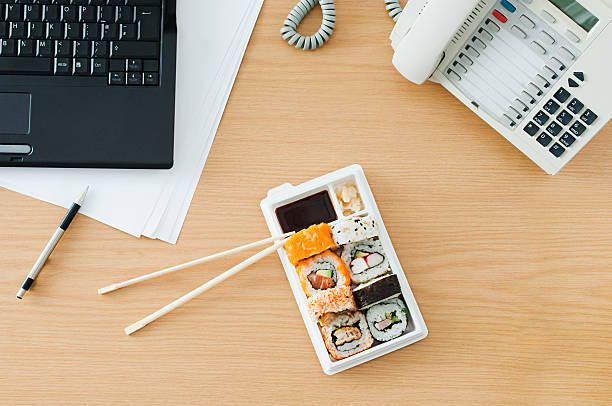 sushi at desk - junk food stock pictures, royalty-free photos & images