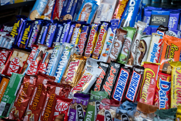 Sweets, confectionary and various well known branded chocolate bars for sale at a small shop on 4th December 2024 in London, United Kingdom.
