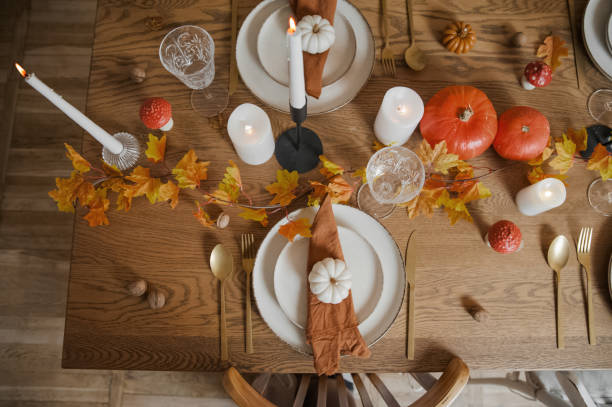 table setting with autumn table decor from candles, pumpkins, leaves, mushrooms - home decoration stock pictures, royalty-free photos & images