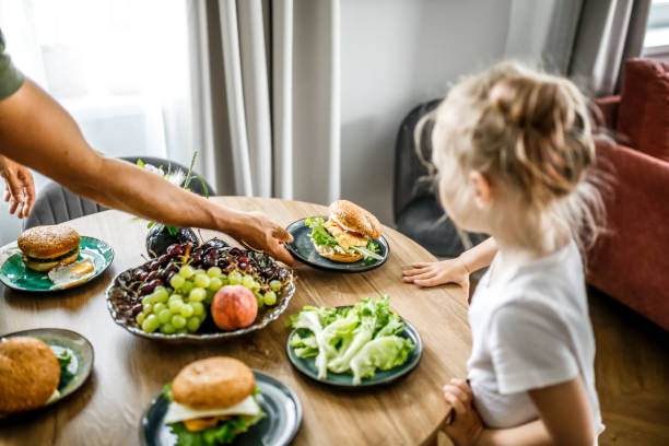 table setting with love: a family coming together for a meal at home. - junk food stock pictures, royalty-free photos & images