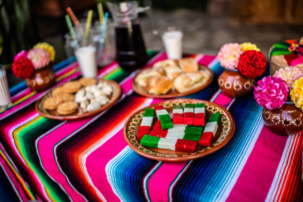 table with decorations, food and a sugar skull piñata for day of the dead - garden decoration stock pictures, royalty-free photos & images