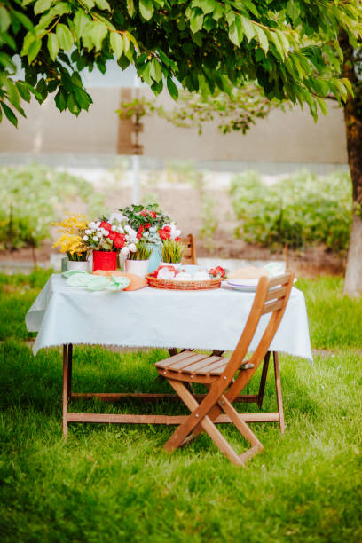table with easter decor on the grass in the backyard garden - garden decoration stock pictures, royalty-free photos & images