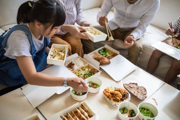 taiwanese family eating chinese take out food at home - junk food stock pictures, royalty-free photos & images