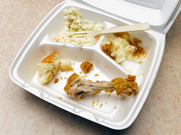 take-out container with eaten fried chicken dinner - junk food stock pictures, royalty-free photos & images