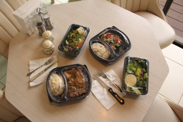 take-out meals at home on kitchen table - junk food stock pictures, royalty-free photos & images