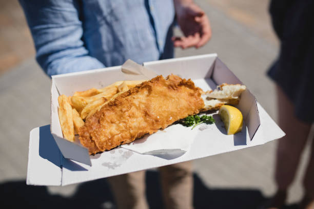 takeaway box of fish and chips - junk food stock pictures, royalty-free photos & images