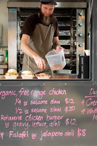takeaway food being prepared on biodegradable plates in a food truck - junk food stock pictures, royalty-free photos & images