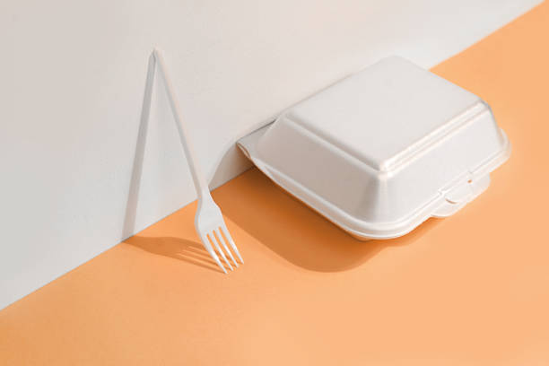 takeaway packaged food. food delivery box and fork on trendy peach color background. - junk food stock pictures, royalty-free photos & images