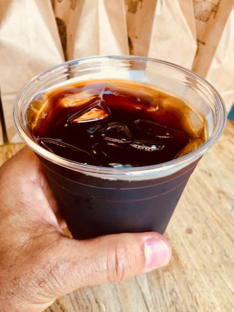 taking my ice cold coffee brew from the coffee counter - junk food stock pictures, royalty-free photos & images