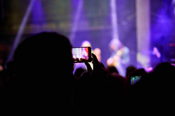 taking pictures and video with a mobile phone - concert stock pictures, royalty-free photos & images