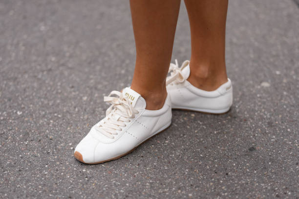 Tamara Kalinic wears white leather Miu Miu sneakers shoes, outside Miu Miu, during the Paris Fashion week Women's Fall/Winter 2025-2026 on March 11,...