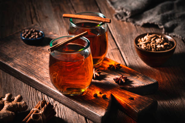tea or chai tea on wooden board with spices cozy hot drink - home decoration stock pictures, royalty-free photos & images