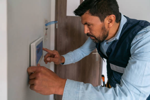 technician installing an alarm system in a smart home - home decoration stock pictures, royalty-free photos & images