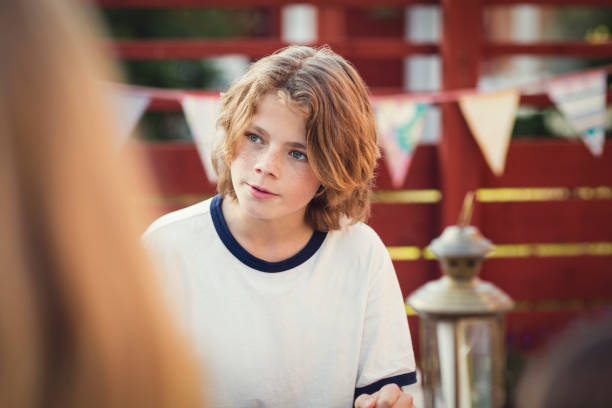 teenage boy looking away in back yard - garden decoration stock pictures, royalty-free photos & images