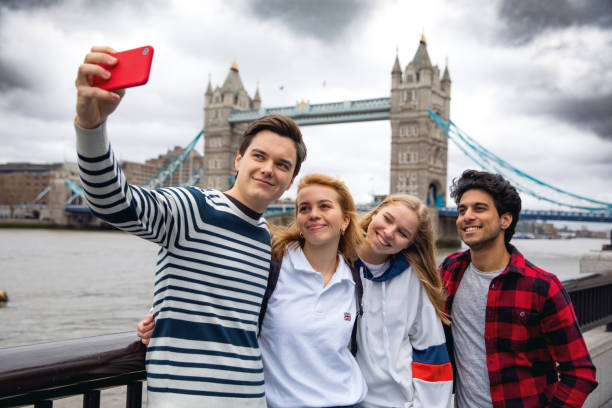 teenage friends visiting london on tower bridge - travel stock pictures, royalty-free photos & images