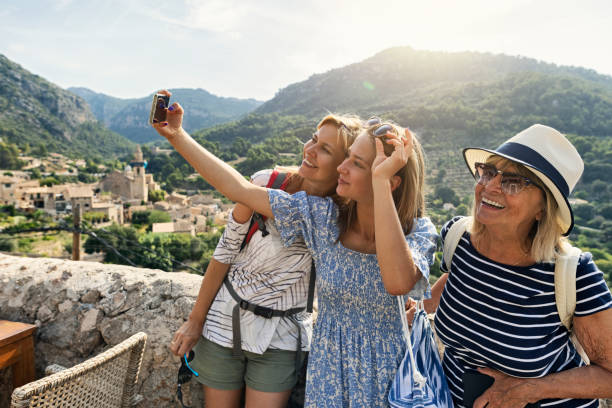 teenage girl, mother and grandmother are sightseeing beautiful town of valldemossa, majorca, spain - travel stock pictures, royalty-free photos & images