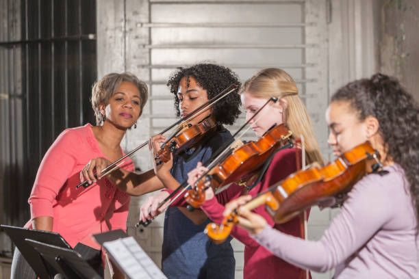teenage violinists with music teacher - concert stock pictures, royalty-free photos & images