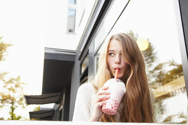 teenager drinking bubble tea - junk food stock pictures, royalty-free photos & images