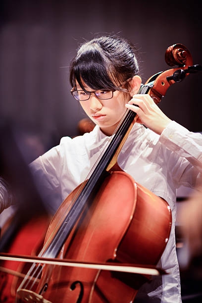 teenager girl is playing cello in a concert - concert stock pictures, royalty-free photos & images