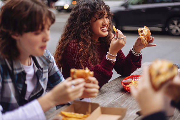 teenagers eating fast food - junk food stock pictures, royalty-free photos & images