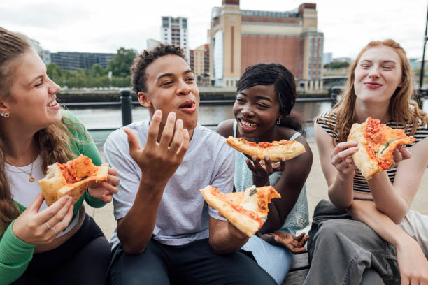 telling a joke with friends - junk food stock pictures, royalty-free photos & images