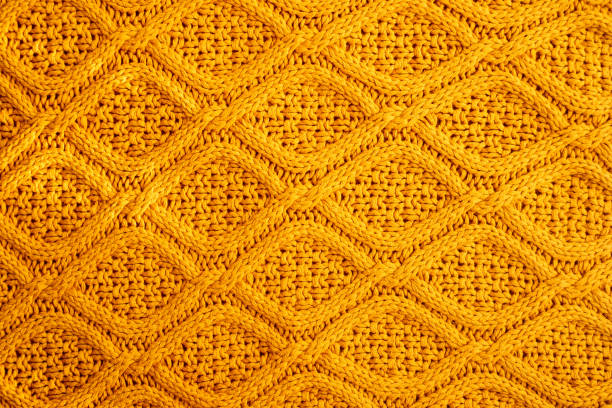 texture of warm knitted sweater. backdrop in yellow color. - home decoration stock pictures, royalty-free photos & images