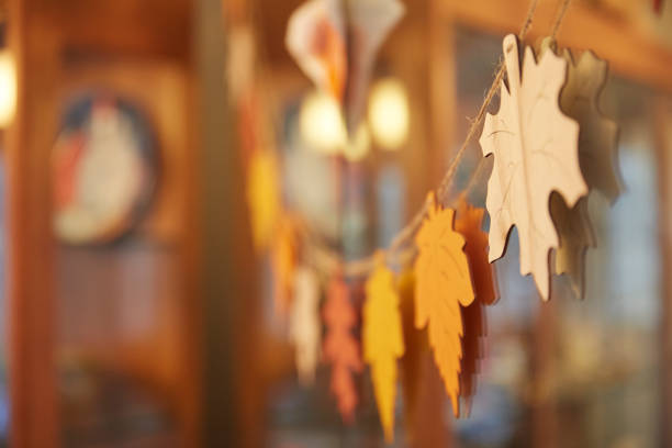 thanksgiving autumn leaves decoration hung up around holiday table. - home decoration stock pictures, royalty-free photos & images